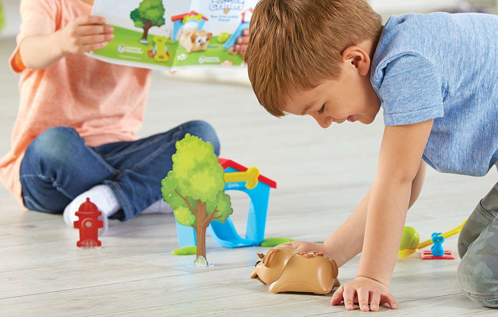 boy and girl playing with coding robot